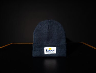 A blue cap with a label. It stands on a simple, dark background.