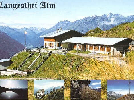 A picturesque alpine pasture surrounded by tall mountains and green meadows. In the foreground, the building of the Langesthei Alm can be seen.