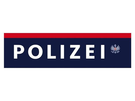 A sign with the word "POLICE" in large letters. Below it is a coat of arms associated with the police.